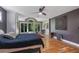 Bright main bedroom featuring a tray ceiling, large window, built-in cabinets, and hardwood floors at 1270 Taylor Oaks Dr, Roswell, GA 30076