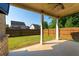 Covered patio with view of fenced-in yard and nearby houses at 2600 Arnold Palmer Way, Duluth, GA 30096