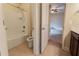 Bathroom featuring tub and shower combo, toilet, and vanity with modern fixtures and a tile floor at 2600 Arnold Palmer Way, Duluth, GA 30096