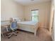 Inviting bedroom with cozy bed, workspace, soft carpet, and natural light from the window at 2600 Arnold Palmer Way, Duluth, GA 30096