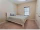 Cozy bedroom with a comfortable bed, soft carpet, and natural light from the window at 2600 Arnold Palmer Way, Duluth, GA 30096