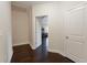 Upstairs hallway with hardwood flooring shows access to a bedroom at 2600 Arnold Palmer Way, Duluth, GA 30096