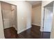 Neutral hallway with hardwood floors showing doors to multiple rooms at 2600 Arnold Palmer Way, Duluth, GA 30096