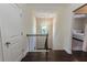 Bright hallway with hardwood floors and a window, leading to bedrooms at 2600 Arnold Palmer Way, Duluth, GA 30096