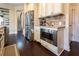 This kitchen features stainless steel appliances, custom cabinets, and hardwood floors at 2600 Arnold Palmer Way, Duluth, GA 30096