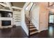 Spacious living room and staircase with hardwood floors and a cozy fireplace at 2600 Arnold Palmer Way, Duluth, GA 30096