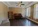 Spacious living room with dark wood floors, a piano, and a comfortable seating area at 2600 Arnold Palmer Way, Duluth, GA 30096