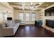 Spacious living room features a coffered ceiling, fireplace, and hardwood floors at 2600 Arnold Palmer Way, Duluth, GA 30096
