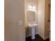 Cozy powder room with neutral tones, a pedestal sink, and modern lighting fixture at 2600 Arnold Palmer Way, Duluth, GA 30096
