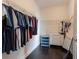 Organized walk-in closet with hanging racks, shelving, and dark hardwood floors at 2600 Arnold Palmer Way, Duluth, GA 30096