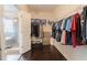 Spacious walk-in closet with ample storage and dark hardwood floors at 2600 Arnold Palmer Way, Duluth, GA 30096