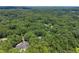 Distant aerial view of a home surrounded by a dense forest landscape at 5455 Malone Ct, Powder Springs, GA 30127