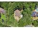 Aerial view of a home nestled among lush green trees with neighboring houses visible in the surrounding area at 5455 Malone Ct, Powder Springs, GA 30127