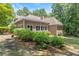 View of the back of the home and backyard with mature landscaping at 5455 Malone Ct, Powder Springs, GA 30127
