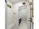 Close-up of a shower with tiled walls, a bench, and bronze fixtures at 5455 Malone Ct, Powder Springs, GA 30127