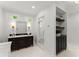 Well-lit bathroom with double vanity, glass shower, and built-in shelving at 5455 Malone Ct, Powder Springs, GA 30127