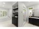 Bright bathroom featuring a soaking tub, walk-in shower, and vanity with dark cabinetry at 5455 Malone Ct, Powder Springs, GA 30127
