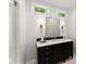 Bathroom showcasing a dark vanity with a marble countertop and decorative sconces at 5455 Malone Ct, Powder Springs, GA 30127