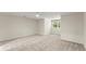 Spacious bedroom featuring neutral paint and carpeting, plus a bright window at 5455 Malone Ct, Powder Springs, GA 30127