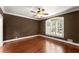 Spacious bedroom with hardwood floors, traditional ceiling fan, large window, and neutral walls at 5455 Malone Ct, Powder Springs, GA 30127