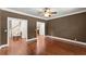 Expansive bedroom featuring pristine hardwood floors, neutral walls and large ceiling fan at 5455 Malone Ct, Powder Springs, GA 30127
