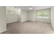 Spacious bedroom with large windows allowing natural light and plush carpeting at 5455 Malone Ct, Powder Springs, GA 30127