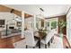 This dining room is open to the living room and features a modern light fixture and backyard view at 5455 Malone Ct, Powder Springs, GA 30127