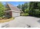 Spacious three car garage with a large driveway and manicured landscaping, enhancing the property's appeal at 5455 Malone Ct, Powder Springs, GA 30127