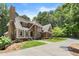 Beautiful home boasts stone accents, brown stucco exterior, manicured lawn and concrete driveway at 5455 Malone Ct, Powder Springs, GA 30127
