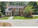 Charming two-story home with a stone and siding exterior, well-manicured lawn, and a paved walkway at 5455 Malone Ct, Powder Springs, GA 30127