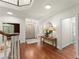 Inviting foyer with pristine hardwood floors, a round mirror and a classic staircase at 5455 Malone Ct, Powder Springs, GA 30127
