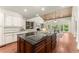 A spacious kitchen features an island, stainless appliances, and an open layout, creating a great space to cook and entertain at 5455 Malone Ct, Powder Springs, GA 30127