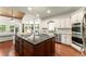 Gourmet kitchen features hardwood floors, stainless appliances, white cabinets and a large island at 5455 Malone Ct, Powder Springs, GA 30127