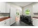 Well-lit laundry room boasts white cabinets, stainless steel sink, and modern washer/dryer units at 5455 Malone Ct, Powder Springs, GA 30127