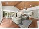 Open living room showing wood floors, wood ceiling beams, and access to the kitchen and dining area at 5455 Malone Ct, Powder Springs, GA 30127
