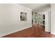 Bright living room with hardwood floors showcasing an open floor plan to dining area at 5455 Malone Ct, Powder Springs, GA 30127