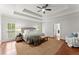 Spacious main bedroom with tray ceiling, area rug, and large windows allowing plenty of natural light at 5455 Malone Ct, Powder Springs, GA 30127