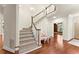 Beautiful staircase with wood railing and carpeted steps in an elegant home at 5455 Malone Ct, Powder Springs, GA 30127