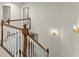 Upstairs staircase with wood railing and white balusters, with hallway views at 5455 Malone Ct, Powder Springs, GA 30127