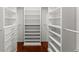 Custom walk-in closet boasts ample storage with shelving, drawers, and modern hardware at 5455 Malone Ct, Powder Springs, GA 30127