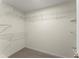 This walk-in closet has neutral walls, plush carpet and wire shelving at 5455 Malone Ct, Powder Springs, GA 30127