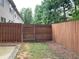 Fenced backyard with a gate, offering a safe and private space for outdoor activities at 5671 Radford Loop, Fairburn, GA 30213