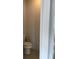 Cozy powder room features a standard toilet and neutral color palette, with a tiled floor at 5671 Radford Loop, Fairburn, GA 30213