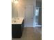 Bathroom featuring double sinks, vanity, mirror, and tiled floor at 5671 Radford Loop, Fairburn, GA 30213