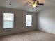 Bedroom featuring neutral carpet, walls, and ceiling fan at 5671 Radford Loop, Fairburn, GA 30213