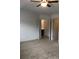 Bedroom featuring neutral carpet, walls, ceiling fan, and bathroom access at 5671 Radford Loop, Fairburn, GA 30213