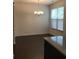 Bright dining room with hardwood floors, natural light, and a decorative chandelier at 5671 Radford Loop, Fairburn, GA 30213