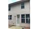 The back exterior reveals multi-paned windows, neutral siding, a patio, and a door at 5671 Radford Loop, Fairburn, GA 30213