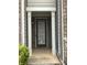 Inviting covered front porch with white columns and brick siding at 5671 Radford Loop, Fairburn, GA 30213
