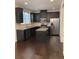 Modern kitchen with stainless steel appliances, granite countertops, and a center island at 5671 Radford Loop, Fairburn, GA 30213